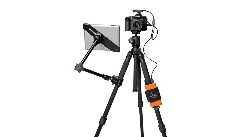 A tripod set up with a tablet mounted in an AeroTab Universal Tablet Mount connected to the tripod via Rock Solid Master Articulating Arm